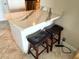 A white breakfast bar with a marble countertop provides an excellent spot for casual dining at 880 Mandalay Ave # N311, Clearwater Beach, FL 33767