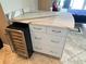 A kitchen area with a built-in wine cooler and marble countertop adds convenience and luxury at 880 Mandalay Ave # N311, Clearwater Beach, FL 33767