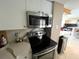Modern kitchen featuring stainless steel microwave and electric range at 880 Mandalay Ave # N311, Clearwater Beach, FL 33767