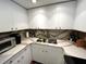 Efficient kitchen with stainless steel appliances, modern countertops, and ample cabinet space at 880 Mandalay Ave # N311, Clearwater Beach, FL 33767