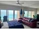 Bright living area with slider doors with ocean views, seating area, and ceiling fan at 880 Mandalay Ave # N311, Clearwater Beach, FL 33767