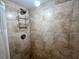 Shower stall with tiled walls and built-in shelving at 880 Mandalay Ave # N311, Clearwater Beach, FL 33767