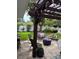 Inviting outdoor patio with a pergola, comfortable seating, and lush landscaping for relaxation and entertaining at 906 Ponce De Leon Blvd, Belleair, FL 33756