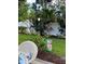 Well-maintained backyard with lush greenery, decorative garden art, and a cozy seating area surrounded by tropical plants at 906 Ponce De Leon Blvd, Belleair, FL 33756