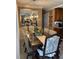 Cozy dining area features a stylish chandelier and a mirrored wall for an elegant touch at 906 Ponce De Leon Blvd, Belleair, FL 33756