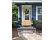 Inviting front door with decorative wreath, elegant stonework, and neat landscaping enhances curb appeal at 906 Ponce De Leon Blvd, Belleair, FL 33756