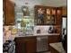Inviting kitchen with granite counters, tile backsplash, and dark wood cabinets at 906 Ponce De Leon Blvd, Belleair, FL 33756