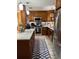 Well-equipped kitchen features stainless steel appliances and a stylish blue and white patterned rug at 906 Ponce De Leon Blvd, Belleair, FL 33756