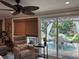 Comfortable living room showcasing sliding glass doors leading to a beautifully landscaped outdoor patio at 906 Ponce De Leon Blvd, Belleair, FL 33756