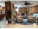 Comfortable living room with plenty of light, two chairs, and an open kitchen at 906 Ponce De Leon Blvd, Belleair, FL 33756