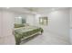 Cozy bedroom with a ceiling fan, two windows, and light gray flooring at 9790 66Th N St # 37, Pinellas Park, FL 33782