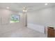 Bedroom with light gray flooring, ceiling fan, and white wood paneled walls at 9790 66Th N St # 37, Pinellas Park, FL 33782