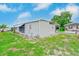 Single-story home with a carport, awnings, and a well-maintained lawn in a serene setting at 9790 66Th N St # 37, Pinellas Park, FL 33782