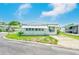 Single-story home with awnings and a well-kept lawn on a sunny corner lot at 9790 66Th N St # 37, Pinellas Park, FL 33782