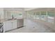 Bright, open-concept kitchen featuring new stainless appliances and laminate flooring at 9790 66Th N St # 37, Pinellas Park, FL 33782