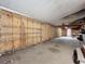 Spacious unfinished basement with built in shelves and plywood walls at 9910 Jerome Dr, New Port Richey, FL 34654