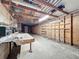 This is a large basement with exposed beams, plywood, shelving, and a workbench at 9910 Jerome Dr, New Port Richey, FL 34654