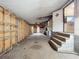 Basement features shelving, stairs, and an exit leading to a laundry area at 9910 Jerome Dr, New Port Richey, FL 34654