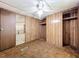 Bedroom featuring wood paneled walls and carpet flooring at 9910 Jerome Dr, New Port Richey, FL 34654