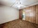 View of the bedroom with a ceiling fan and old brown carpet at 9910 Jerome Dr, New Port Richey, FL 34654