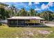 View of the back of the home and the attached screened in porch at 9910 Jerome Dr, New Port Richey, FL 34654