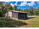 View of a single story home and the attached screened in porch at 9910 Jerome Dr, New Port Richey, FL 34654