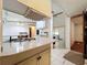 Kitchen area featuring tile countertops, ample lighting, and a connected dining area at 9910 Jerome Dr, New Port Richey, FL 34654