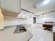 A well-lit kitchen with appliances and tile flooring at 9910 Jerome Dr, New Port Richey, FL 34654