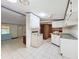 The kitchen has white appliances, cabinets, and tiled floors at 9910 Jerome Dr, New Port Richey, FL 34654