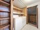 This laundry room has a washer and dryer with shelving and white tiled floor at 9910 Jerome Dr, New Port Richey, FL 34654
