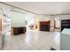 Spacious living room with tile flooring and a wooden fireplace at 9910 Jerome Dr, New Port Richey, FL 34654