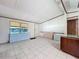 Open-concept living area with neutral tile flooring and natural light at 9910 Jerome Dr, New Port Richey, FL 34654