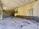 View of the covered, screened in porch with a stained concrete floor at 9910 Jerome Dr, New Port Richey, FL 34654