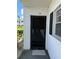 Front door with black security gate and trim, next to the window at 102 47Th Avenue W Dr # 136, Bradenton, FL 34207