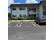 View of the building exterior with a car parked in a designated parking spot at 102 47Th Avenue W Dr # 136, Bradenton, FL 34207