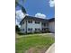 Well-maintained two-story building with lush landscaping and clearly marked parking spaces at 102 47Th Avenue W Dr # 136, Bradenton, FL 34207