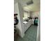 The kitchen features tile flooring, bright lighting, and ample counter space at 102 47Th Avenue W Dr # 136, Bradenton, FL 34207