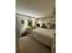 Large primary bedroom with warm carpeting and coordinated furnishings at 102 47Th Avenue W Dr # 136, Bradenton, FL 34207