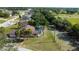 An aerial view of a house featuring a screened-in pool, lush landscaping, and a spacious backyard at 10365 Lynnhaven Rd, Spring Hill, FL 34608