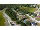 Overhead shot of homes near green spaces and a pond, offering a blend of nature and neighborhood charm at 10365 Lynnhaven Rd, Spring Hill, FL 34608