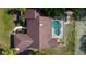 Aerial view of a home featuring a private pool and well-maintained roof at 10365 Lynnhaven Rd, Spring Hill, FL 34608