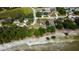 Aerial view of a home featuring well-maintained landscaping, and nearby lake access at 10365 Lynnhaven Rd, Spring Hill, FL 34608