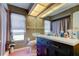 Bathroom with modern vanity and cabinetry, stylish mirror and lighting and pink tile at 10365 Lynnhaven Rd, Spring Hill, FL 34608