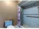 Bathroom featuring a tiled walk-in shower, toilet, and grab bar at 10365 Lynnhaven Rd, Spring Hill, FL 34608