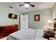 Cozy bedroom featuring a ceiling fan, dresser with TV, and neutral paint scheme at 10365 Lynnhaven Rd, Spring Hill, FL 34608