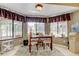 Cozy dining area with large windows overlooking a pool with lots of natural light at 10365 Lynnhaven Rd, Spring Hill, FL 34608