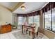 Cozy dining area with large windows overlooking a pool and outdoor space at 10365 Lynnhaven Rd, Spring Hill, FL 34608