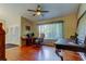 Home office space featuring hardwood floors, large windows, and a ceiling fan at 10365 Lynnhaven Rd, Spring Hill, FL 34608