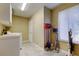 Laundry room includes a sink, storage cabinets, and utility cleaning supplies at 10365 Lynnhaven Rd, Spring Hill, FL 34608