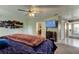 Main bedroom with en-suite bathroom, fan, and wall mounted TV at 10365 Lynnhaven Rd, Spring Hill, FL 34608